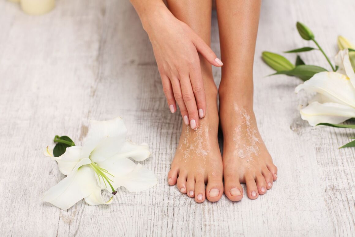 Eine Frau reinigt ihre Füße mit ätherischen Öle